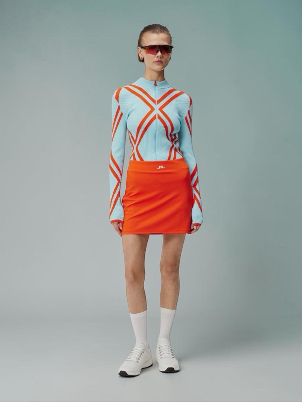 J. Lindeberg Raphaela Mid Golf Skort in Tangerine Tango | Luxury Activewear